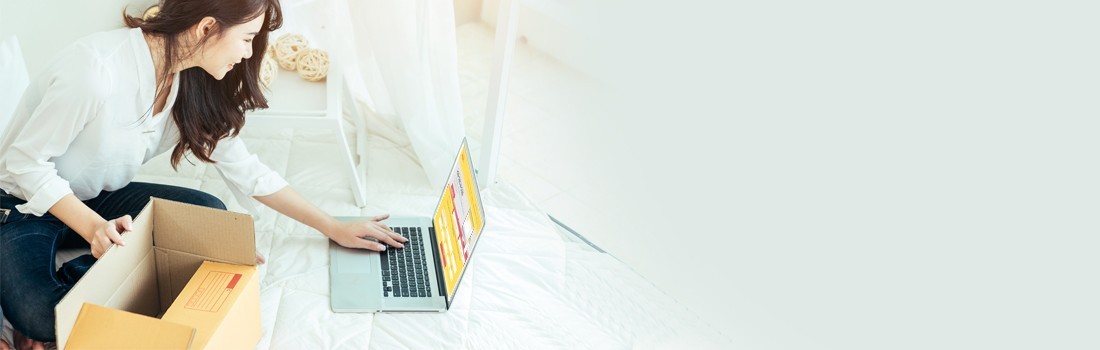 Woman creating DHL shipment on laptop